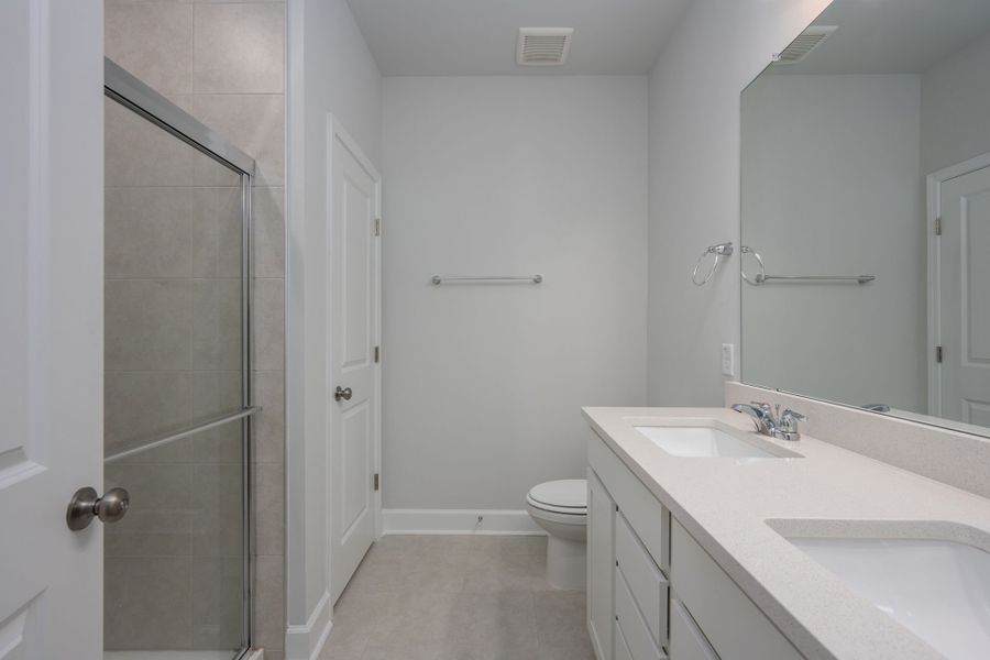 Owner's Bathroom showcases a dual-sink vanity and a shower. Owner's Bathroom showcases a dual-sink vanity and a shower.