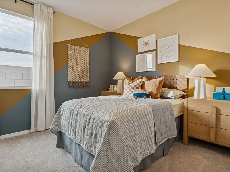 A bedroom with a bed and lamps.