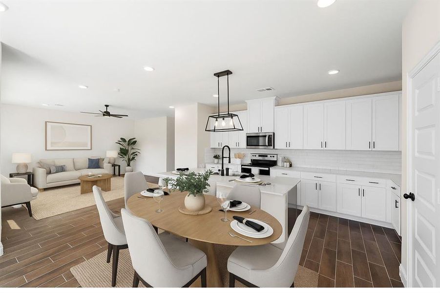 Kitchen with tasteful backsplash, pendant lighting, wood finish floors, a kitchen island with sink, and appliances with stainless steel finishes Kitchen with tasteful backsplash, pendant lighting, wood finish floors, a kitchen island with sink, and appliances with stainless steel finishes