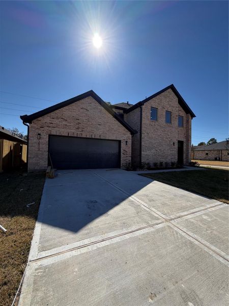 Front exterior of a new home in , Spring, TX, highlighting curb appeal (Image 1). Front exterior of a new home in , Spring, TX, highlighting curb appeal (Image 1).