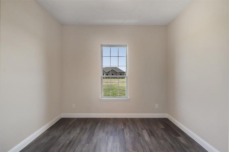 Spare room with dark hardwood / wood-style floors