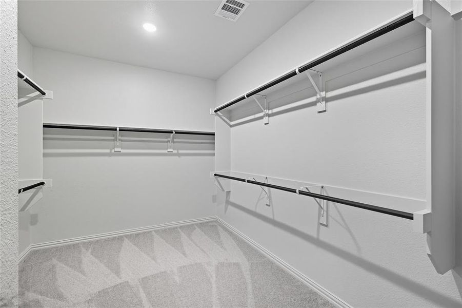 Walk in closet with light carpet Walk in closet with light carpet