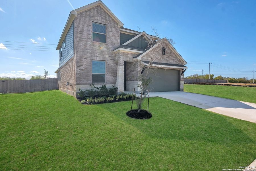 Front exterior of a new home in Morgan Meadows, San Antonio, TX, highlighting curb appeal (Image 1). Front exterior of a new home in Morgan Meadows, San Antonio, TX, highlighting curb appeal (Image 1).