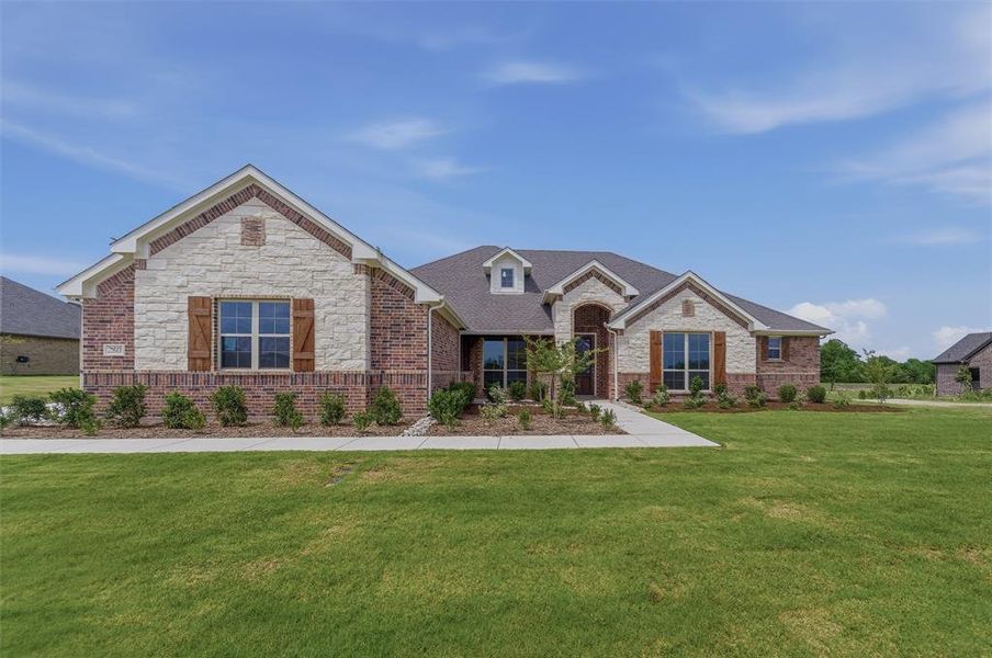 Single-story residence featuring a brick and stone facade Single-story residence featuring a brick and stone facade