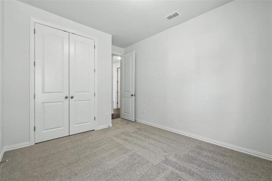 Unfurnished bedroom featuring carpet floors and a closet