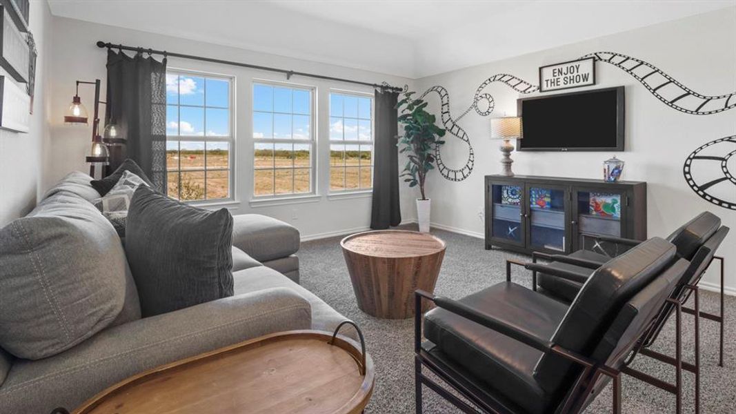 Living area featuring carpet floors and baseboards