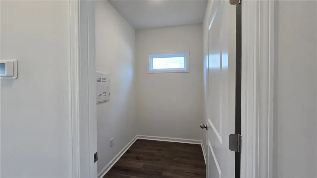 A small alcove with rich wood-toned flooring and n