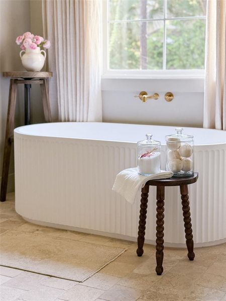 Primary bath has a Freestanding fluted soaking tub with a wall-mounted unlaquered brass faucet Primary bath has a Freestanding fluted soaking tub with a wall-mounted unlaquered brass faucet