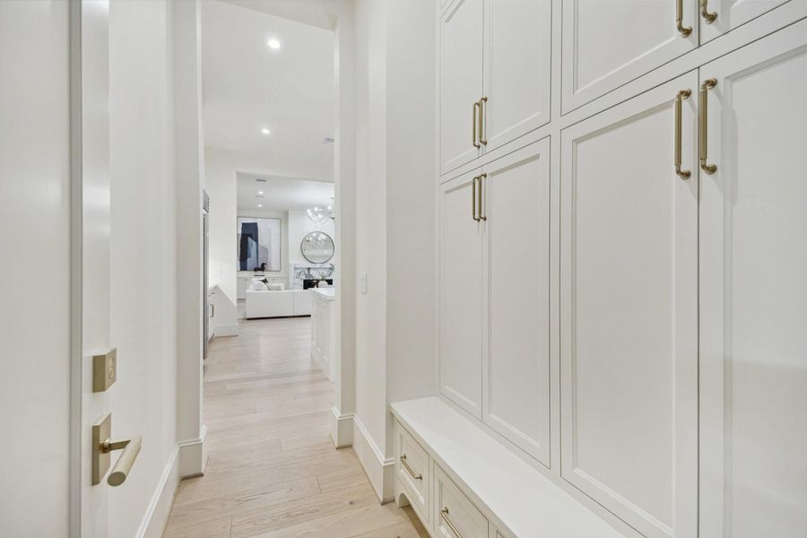 [Mudroom] Located off the garage, the mudroom offers ample storage and a built-in seating bench, creating an efficient and organized space.