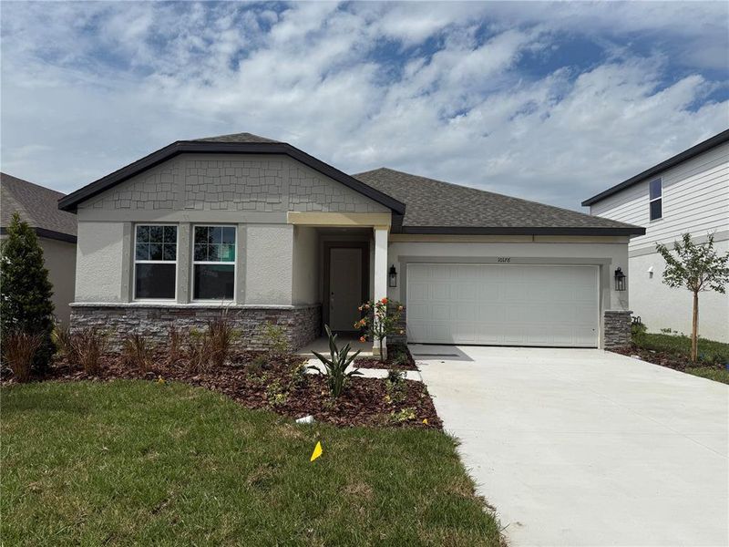 Front exterior of a new home in Oakfield Trails Traditional, Parrish, FL, highlighting curb appeal (Image 1).