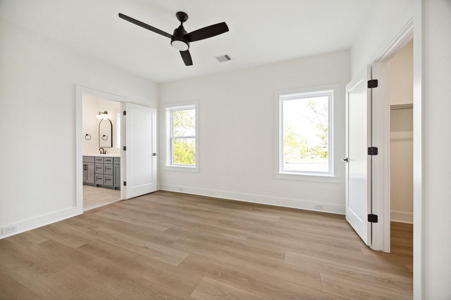 Third bedroom offers a walk-in closet, modern ceiling fan and access to the jack and jill bath