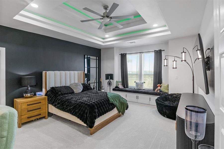 Carpeted bedroom with a ceiling fan and recessed lighting Carpeted bedroom with a ceiling fan and recessed lighting