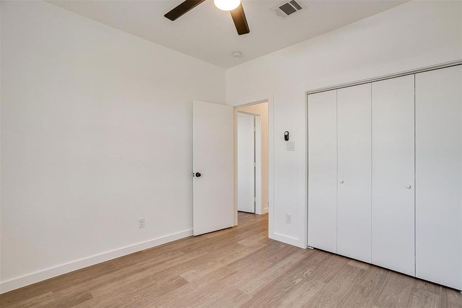Unfurnished bedroom featuring light wood-style flooring, a closet, baseboards, and ceiling fan Unfurnished bedroom featuring light wood-style flooring, a closet, baseboards, and ceiling fan