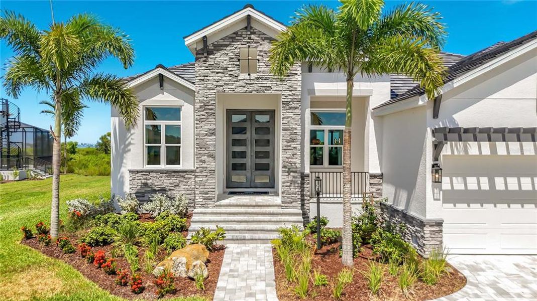 Front exterior of a new home in Legends Bay, Bradenton, FL, highlighting curb appeal (Image 24). Front exterior of a new home in Legends Bay, Bradenton, FL, highlighting curb appeal (Image 24).
