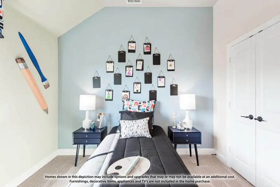 Kids bedroom with light blue accent wall, clipboard art display, and twin bed with navy nightstands Kids bedroom with light blue accent wall, clipboard art display, and twin bed with navy nightstands
