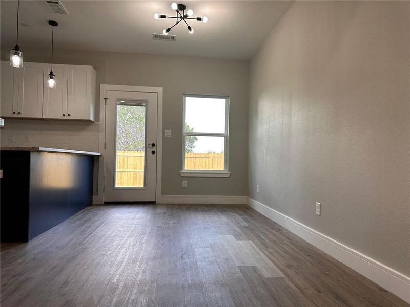 Dining room. Breakfast area. hanging lights can be controlled remotely.