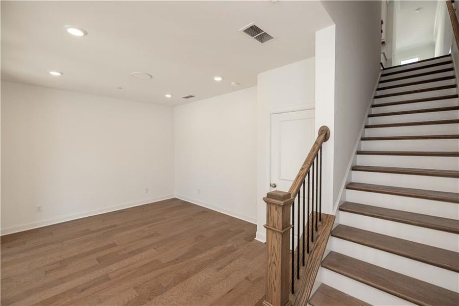 Hardwood stair treads lead to the upper levels.