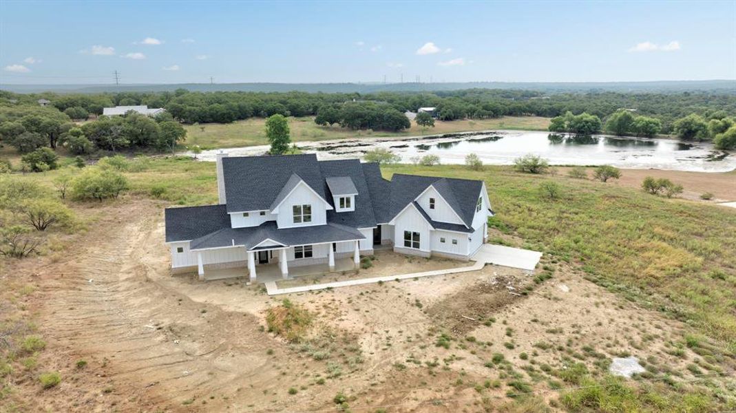 Aerial view of property and surrounding area featuring a tree filled landscape Aerial view of property and surrounding area featuring a tree filled landscape