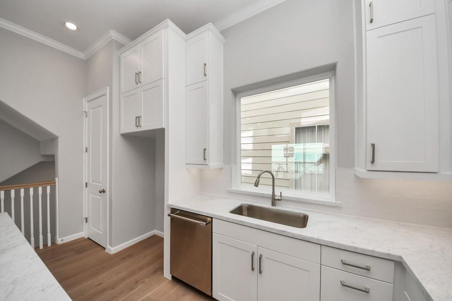Alternate view of the kitchen showcasing custom cabinetry, premium finishes, and open-concept design. Alternate view of the kitchen showcasing custom cabinetry, premium finishes, and open-concept design.