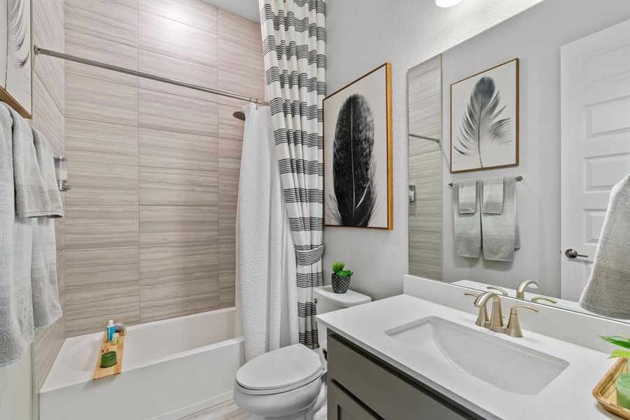 This graceful bathroom includes a soaking tub/shower combo.