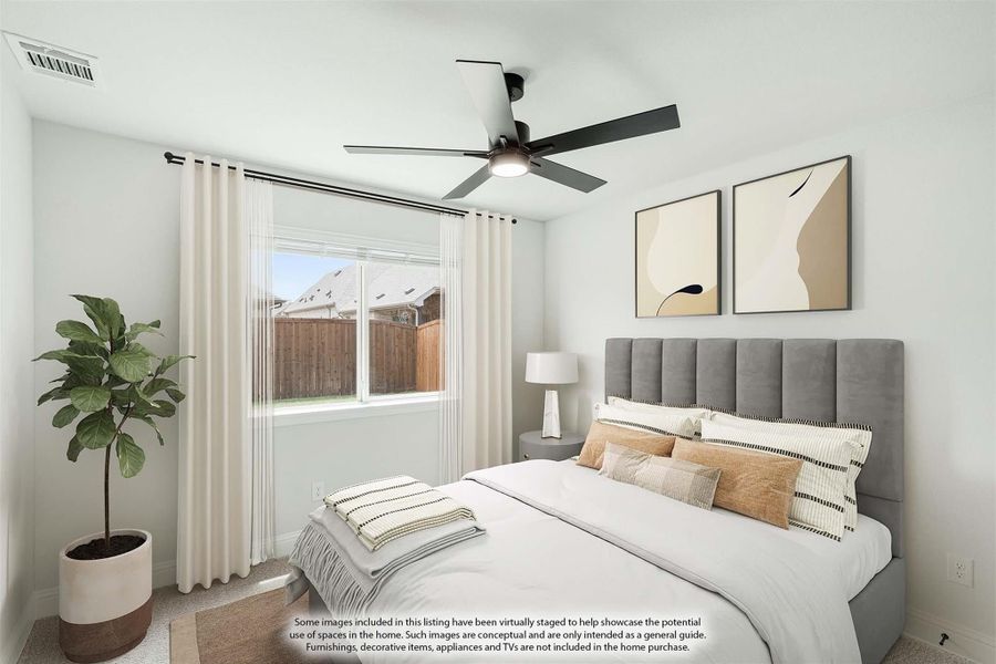 Bedroom with gray upholstered headboard, ceiling fan, white curtains, and a window with backyard view