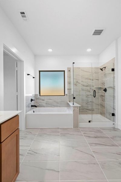 Enjoy the best of both worlds with a separate soaking tub for relaxation and a walk-in glass shower for convenience. Enjoy the best of both worlds with a separate soaking tub for relaxation and a walk-in glass shower for convenience.