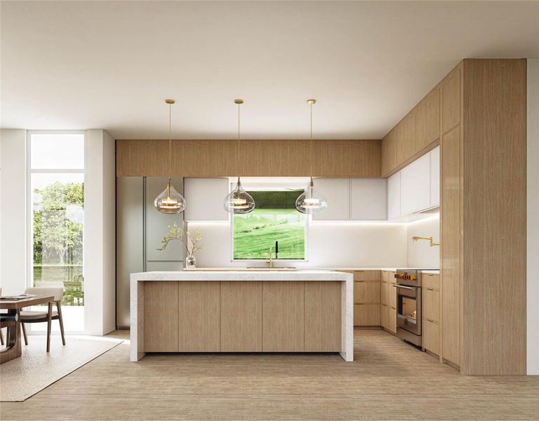 Kitchen featuring high end stove, light brown cabinetry, light countertops, light wood-style floors, and a sink