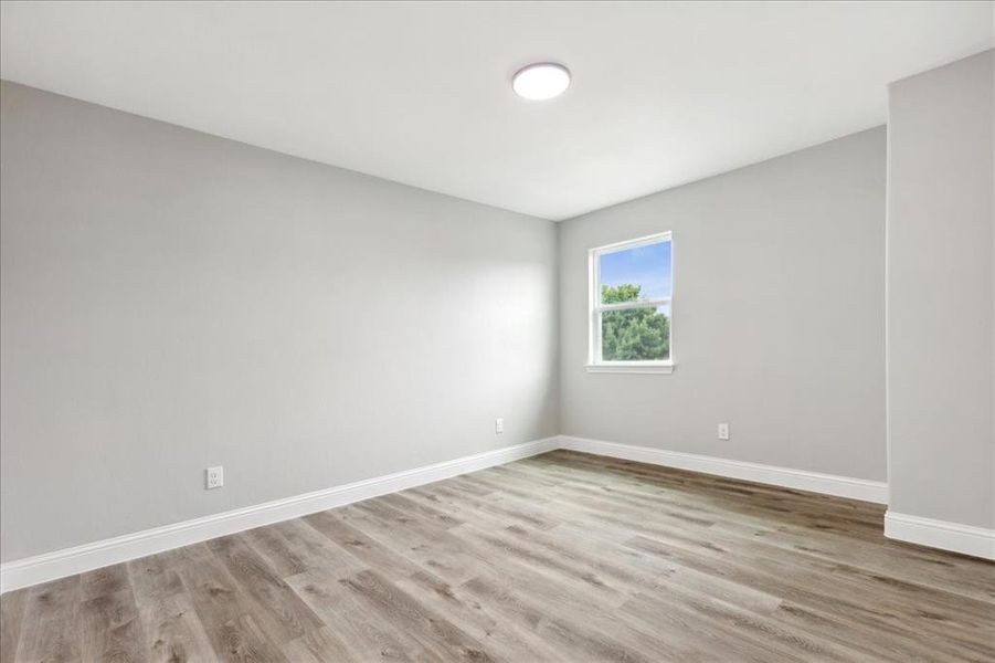 Spare room with wood-type flooring