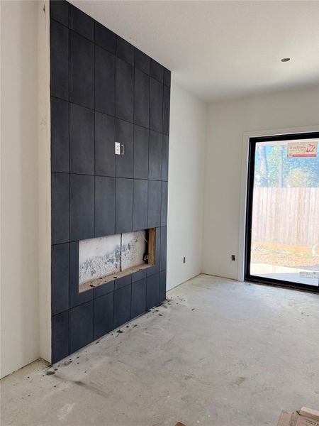 The floor-to-ceiling black tile fireplace is a true statement piece - crafted with modern 12x24 tiles and precise grout work to create a sleek vertical focal point. Once the electric insert and mantle are complete, this will be the heart of the home - balancing comfort, drama, and design sophistication. The floor-to-ceiling black tile fireplace is a true statement piece - crafted with modern 12x24 tiles and precise grout work to create a sleek vertical focal point. Once the electric insert and mantle are complete, this will be the heart of the home - balancing comfort, drama, and design sophistication.