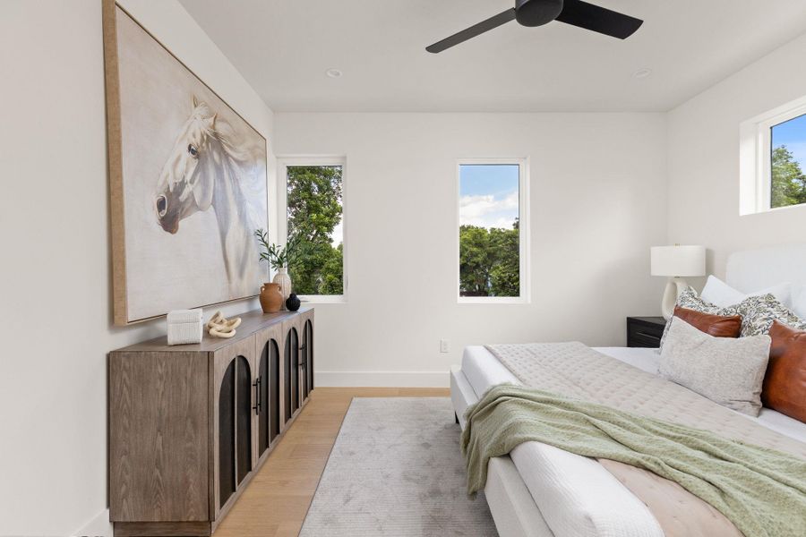 Hardwood floors and bright windows illuminate this generously sized bedroom. Hardwood floors and bright windows illuminate this generously sized bedroom.