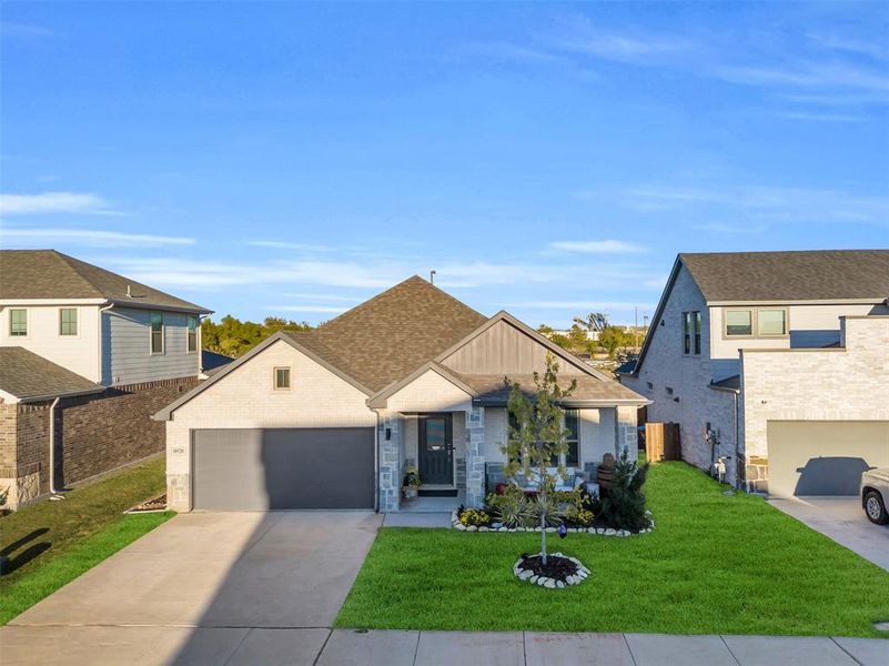 View of front of home with a front lawn and a garage