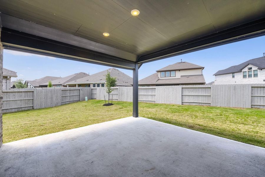 Perfect for hosting outdoor gatherings, this spacious covered patio opens to a private backyard