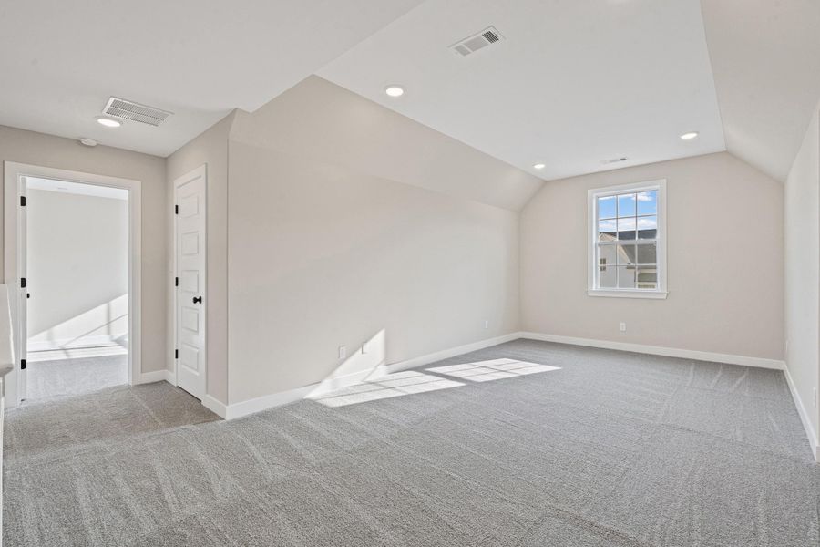 Bonus room featuring light carpet, recessed lighting, and lofted ceiling