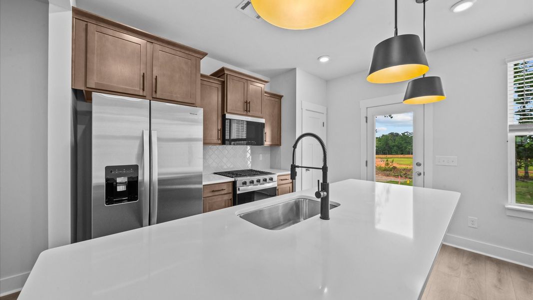 9-foot kitchen island with white quartz countertops in two story townhome at Ransdell Pointe by DRB Homes in Spartanburg, SC