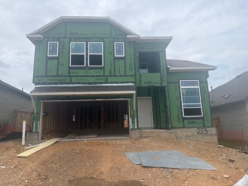 Unfinished property featuring an attached garage