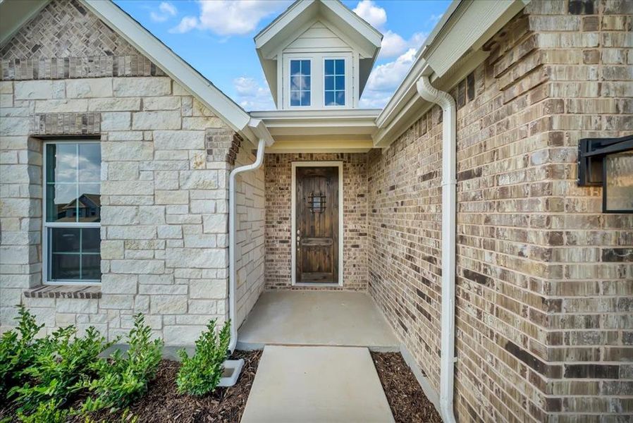 Front exterior of a new home in Liberty Pointe, Gainesville, TX, highlighting curb appeal (Image 20).