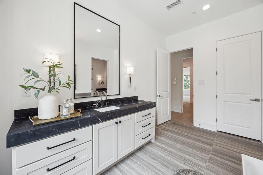 Custom Benedettini cabinetry, Nero Marquina Marble countertops, Kallista Perfect under-mount centric rectangle sinks with Kallista One contemporary fixtures, polished nickel and matte black sconces complete this elegant and serene primary retreat. Custom Benedettini cabinetry, Nero Marquina Marble countertops, Kallista Perfect under-mount centric rectangle sinks with Kallista One contemporary fixtures, polished nickel and matte black sconces complete this elegant and serene primary retreat.