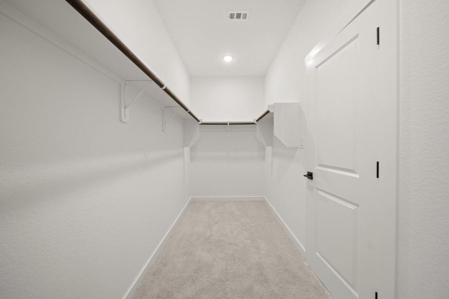 Walk-in closet in the primary suite (*Photo not of actual home and used for illustration purposes only.)