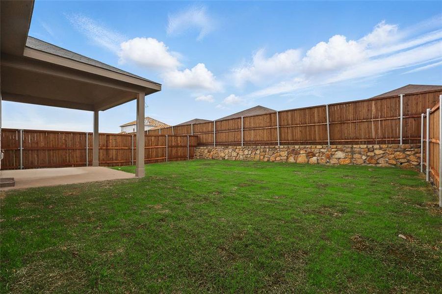 Fenced backyard featuring a patio area