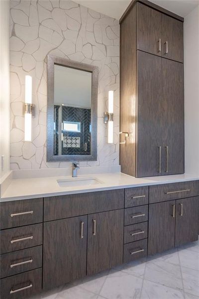 Bathroom with vanity and decorative backsplash