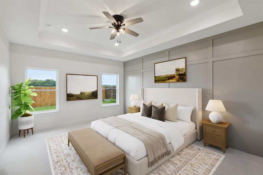 Bedroom featuring a tray ceiling, recessed lighting, and a decorative wall