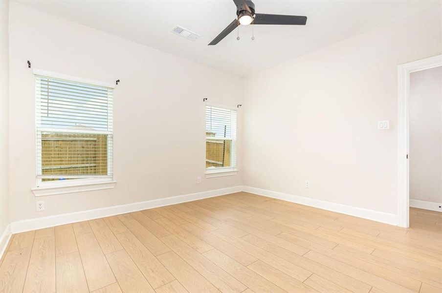 Empty room with light wood-style flooring and ceiling fan Empty room with light wood-style flooring and ceiling fan