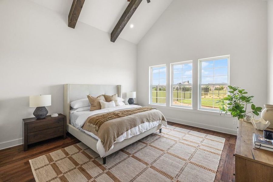 Virtually staged Primary Bedroom featuring multiple windows, engineered wood flooring, and high vaulted ceiling Virtually staged Primary Bedroom featuring multiple windows, engineered wood flooring, and high vaulted ceiling