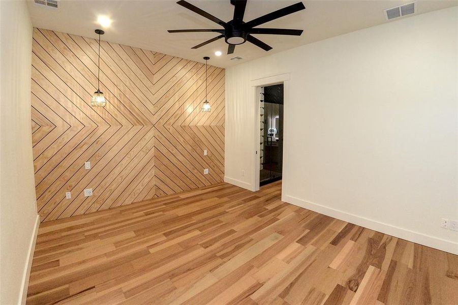 Primary bedroom with accent wall, bedside lights and wired up for optional desk.