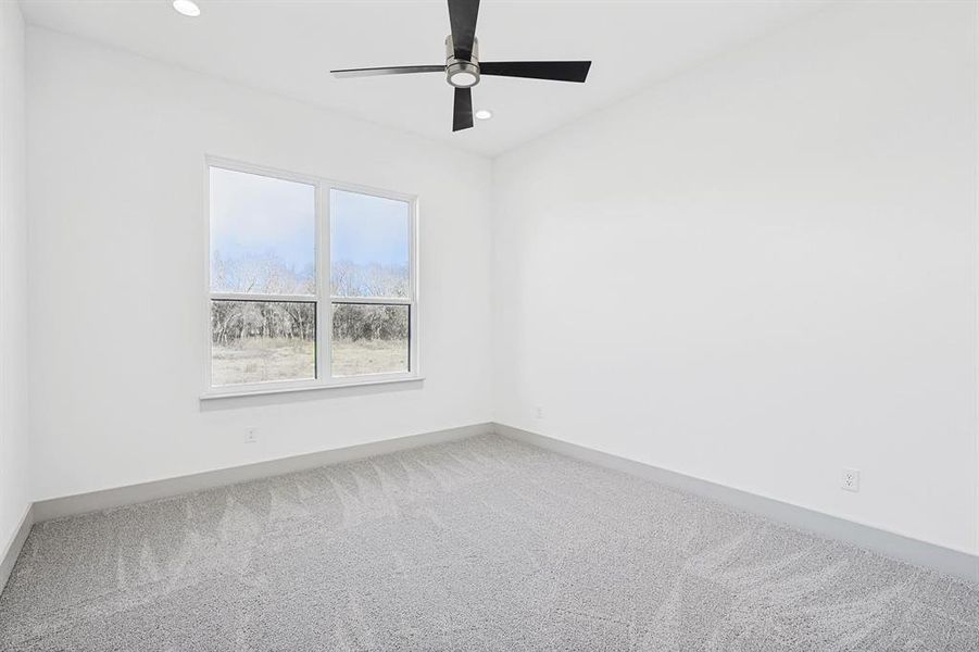 Empty room with carpet, recessed lighting, and a ceiling fan Empty room with carpet, recessed lighting, and a ceiling fan