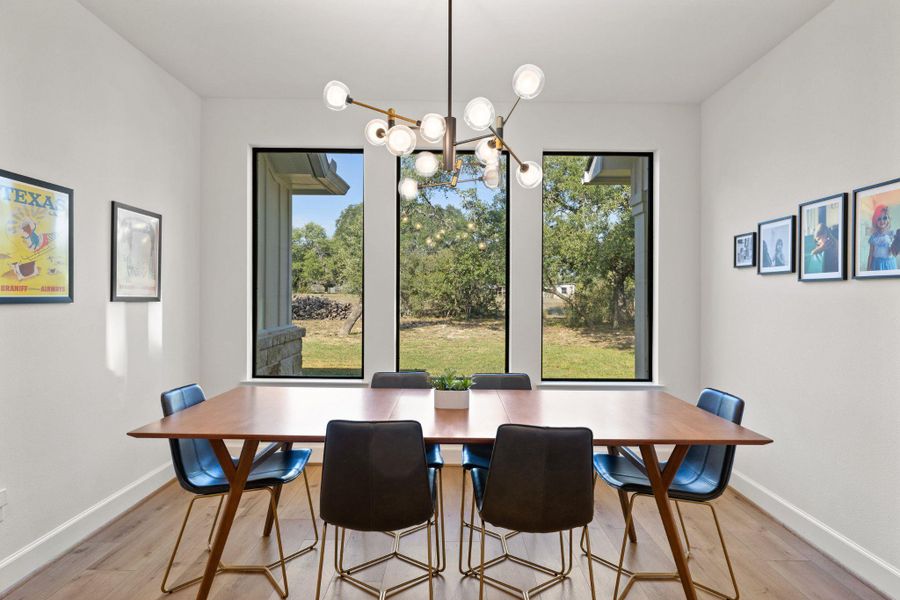 Dining space featuring light wood-type flooring and a chandelier