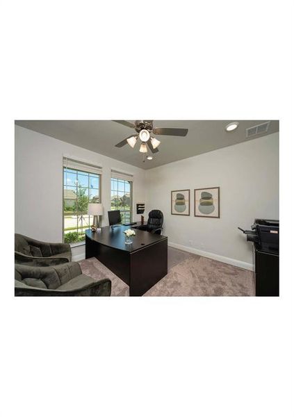 Carpeted home office with ceiling fan