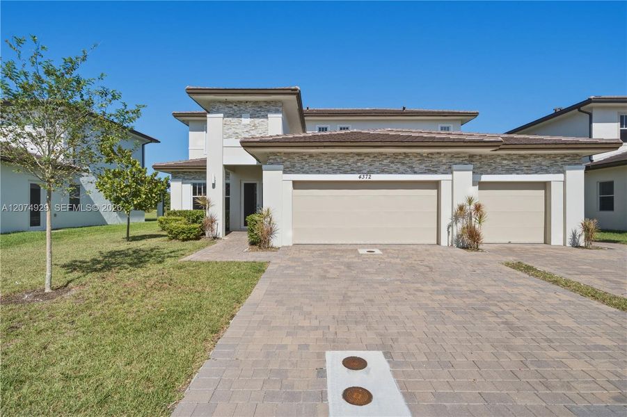 Front exterior of a new home in , Davie, FL, highlighting curb appeal (Image 2). Front exterior of a new home in , Davie, FL, highlighting curb appeal (Image 2).
