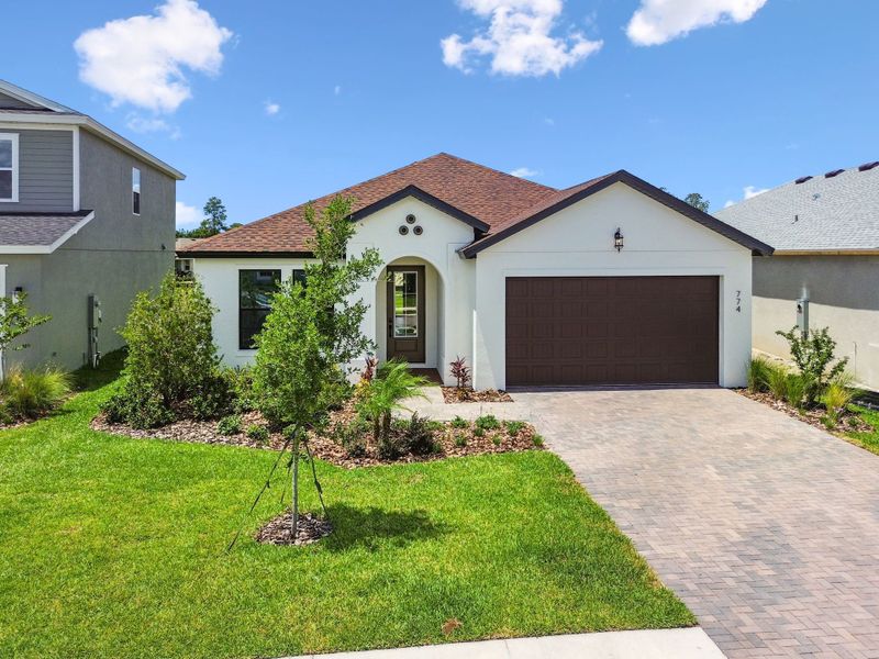 Front exterior of a new home in Avalon West, Spring Hill, FL, highlighting curb appeal (Image 9).