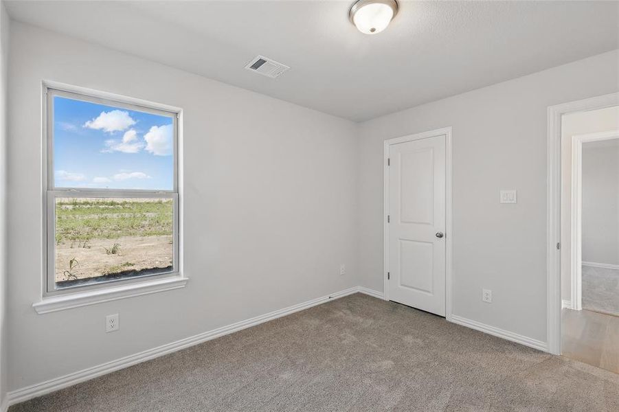 Unfurnished bedroom with carpet and baseboards Unfurnished bedroom with carpet and baseboards